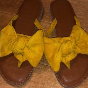 Yellow bow flip flops